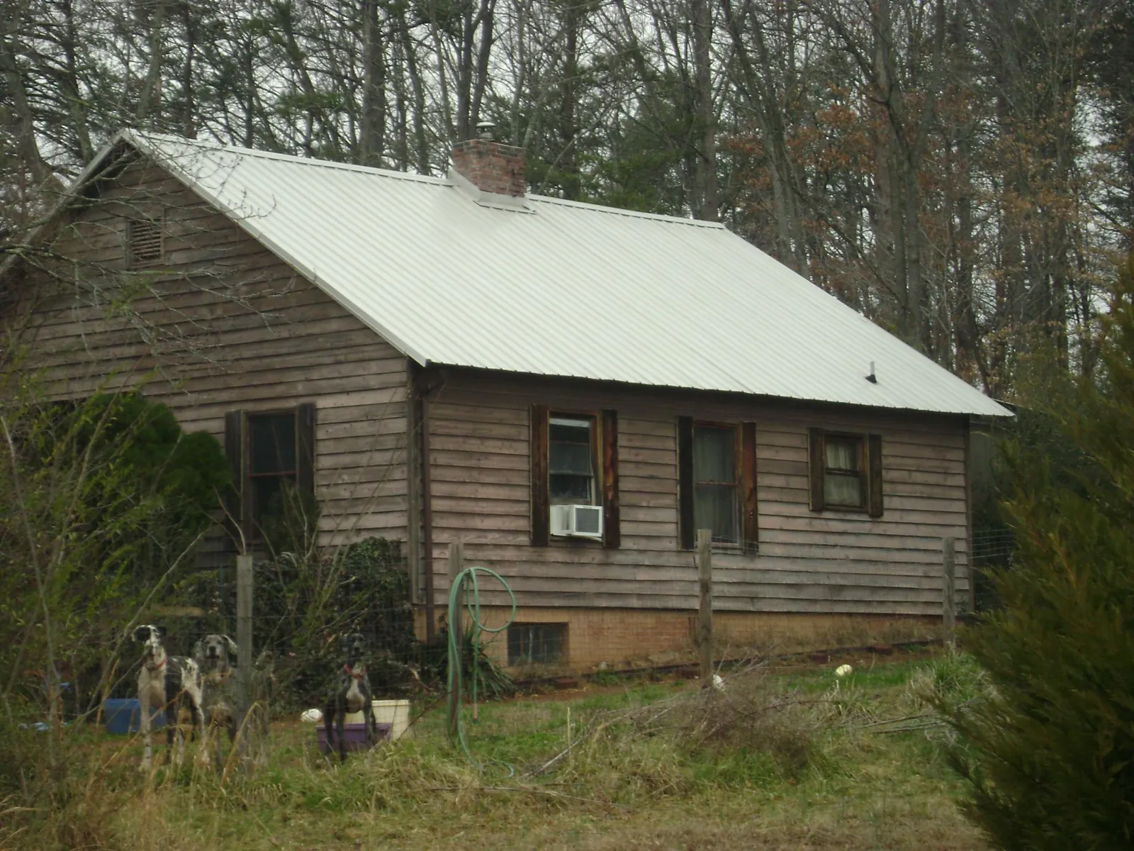White metal roof on an old wood sided farmhouse, from a Metal Roof Installation job in Hidden Valley